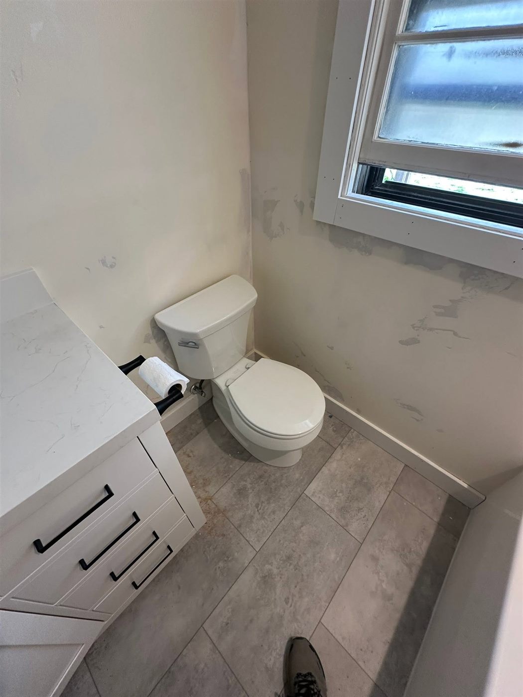 Finished bathroom with toilet and vanity
