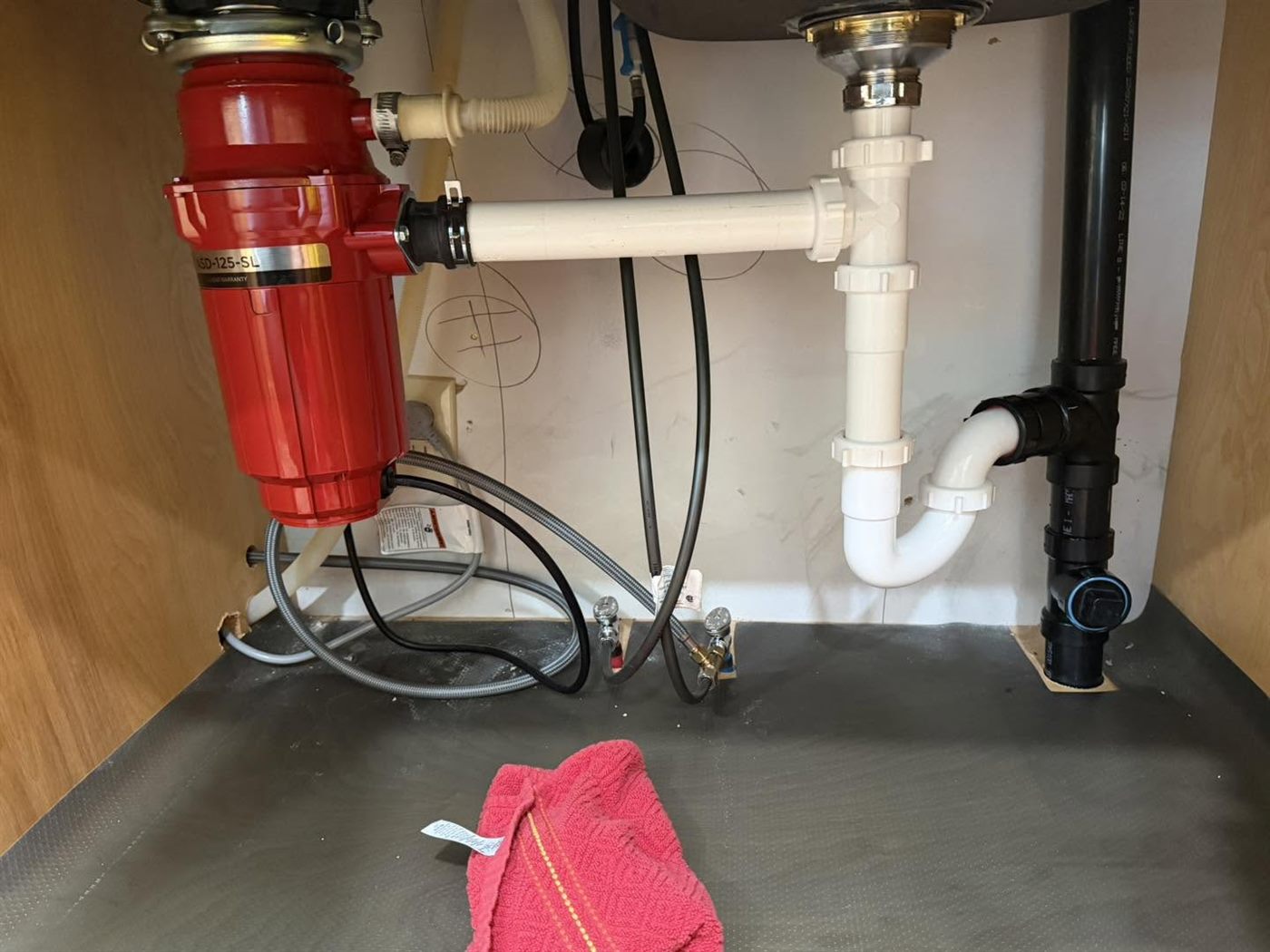 Tidy under-sink plumbing with a garbage disposal